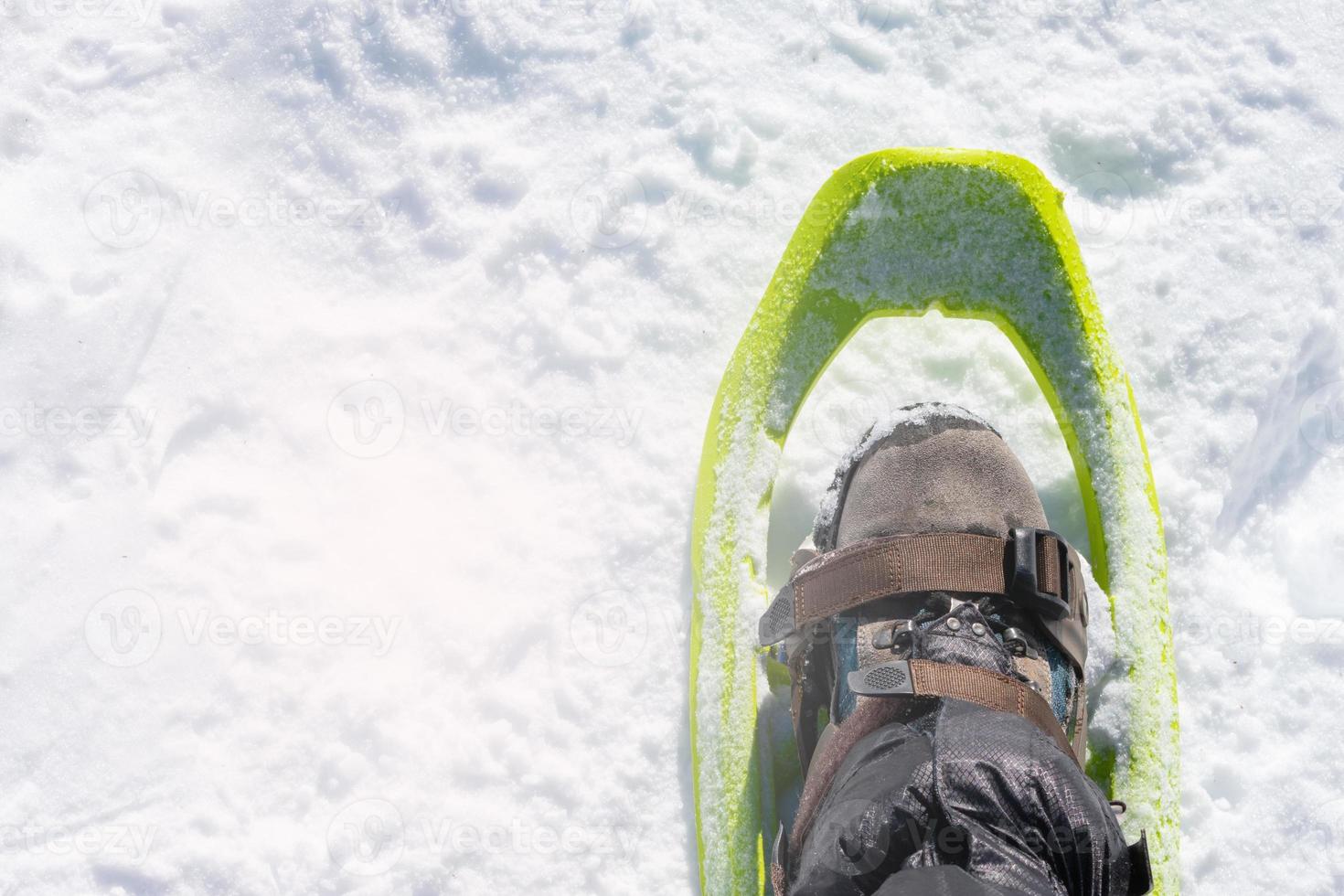 detail of snowshoe on mountaineer's foot photo