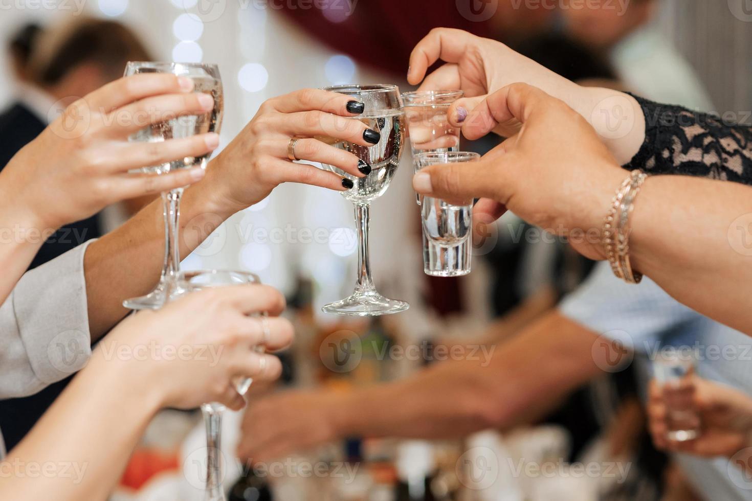 hands with glasses. the clink of glasses and toast. photo