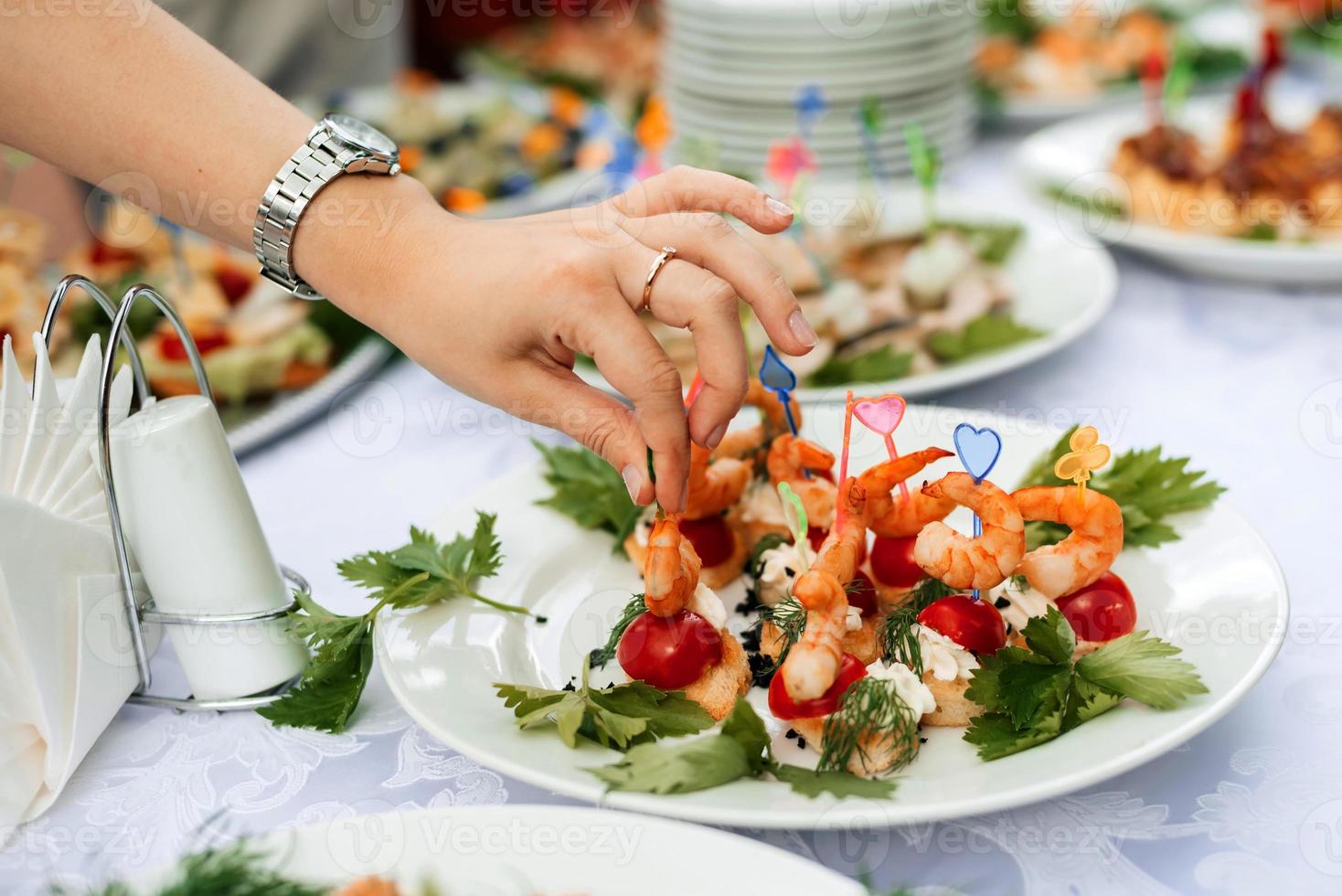 table set with light snacks, canapes and glasses photo