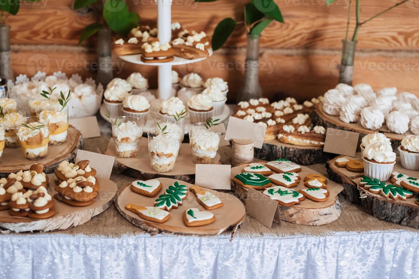 Table with loads of cakes, cupcakes, cookies and cake pops photo