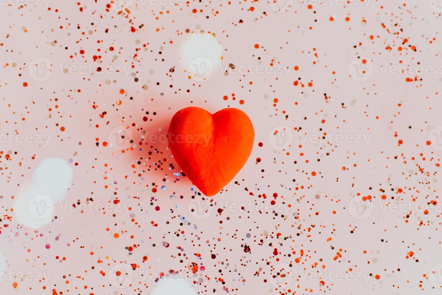 Red heart on pink background with confetti. Valentine's Day template photo