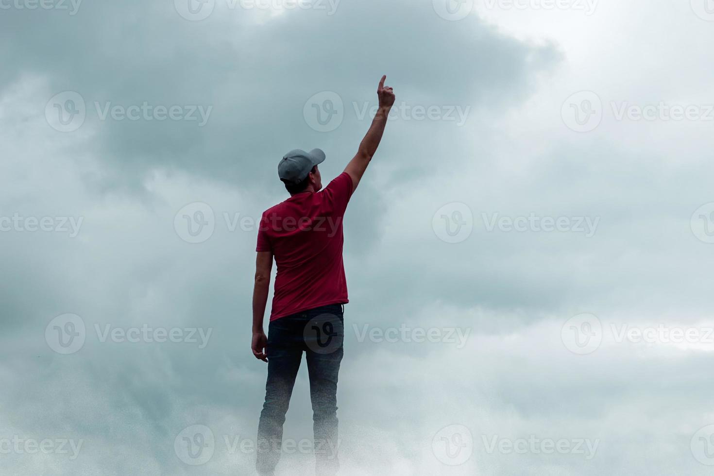 man portrait gesturing in the sky and clouds photo