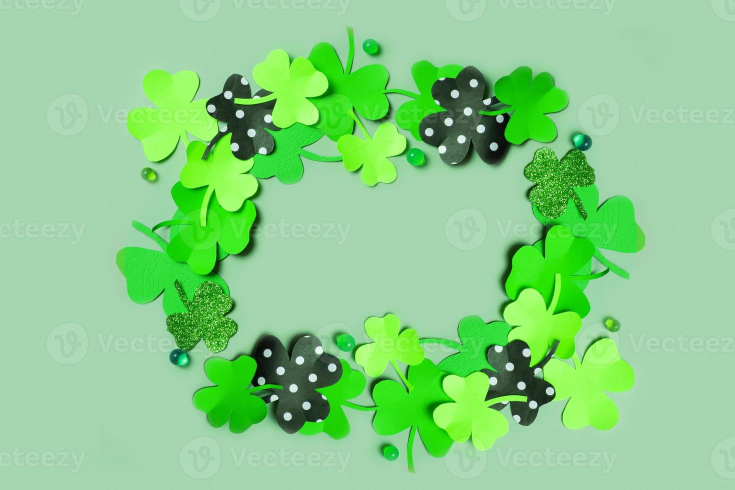 St. Patrick's Day frame background. Paper clover leaves on colored background with copy space photo