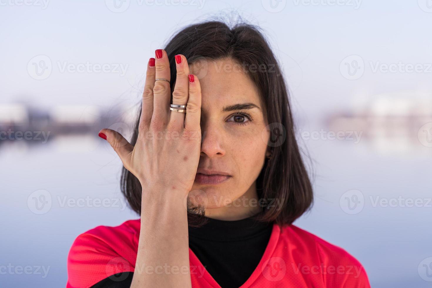 portrait of young female athlete is playing with her hands on a boat in the harbor photo