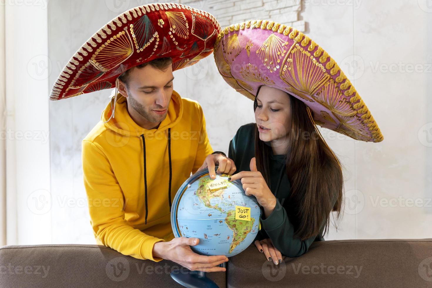 young couple is planning the next trip by choosing the destination photo