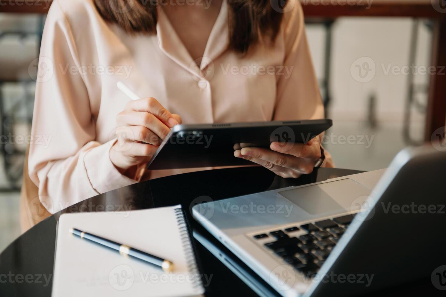 business documents on office table with smart phone and digital tablet and graph financial and woman working at office photo