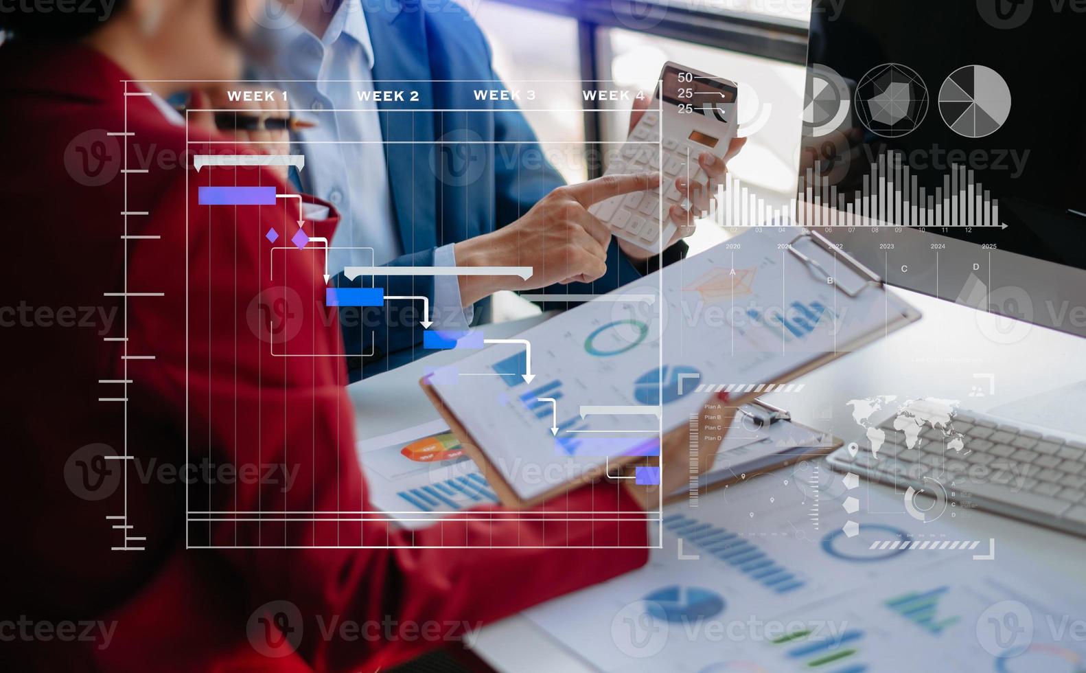 Businessman hand Project manager working and update tasks and Gantt chart scheduling virtual diagram.with smart phone, tablet and laptop photo