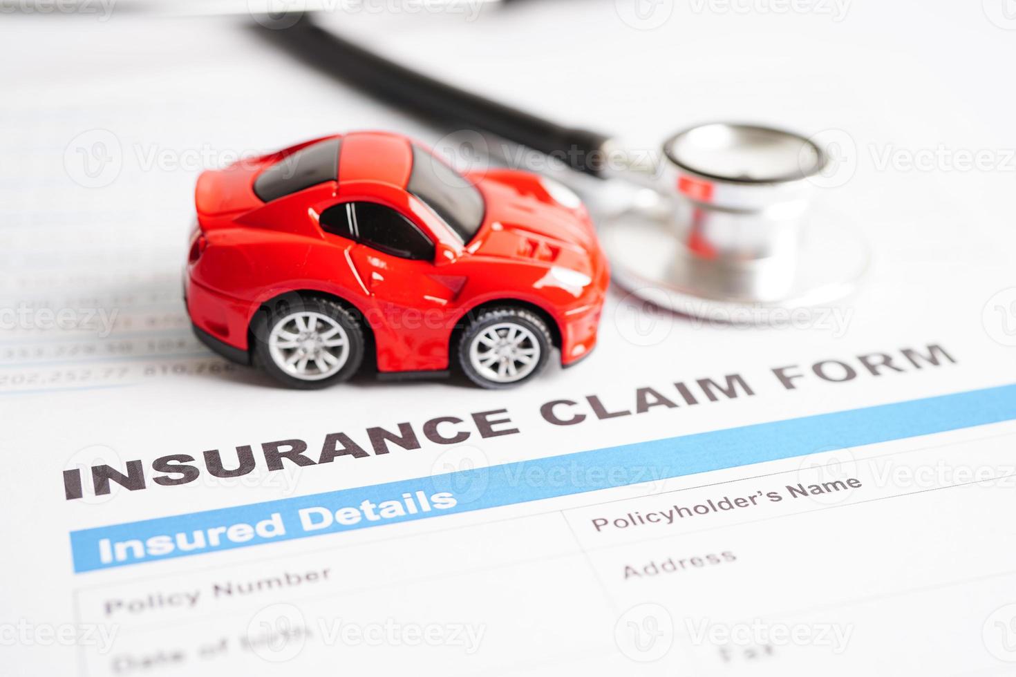 Stethoscope on Insurance claim accident car form, Car loan, insurance and leasing time concepts. photo