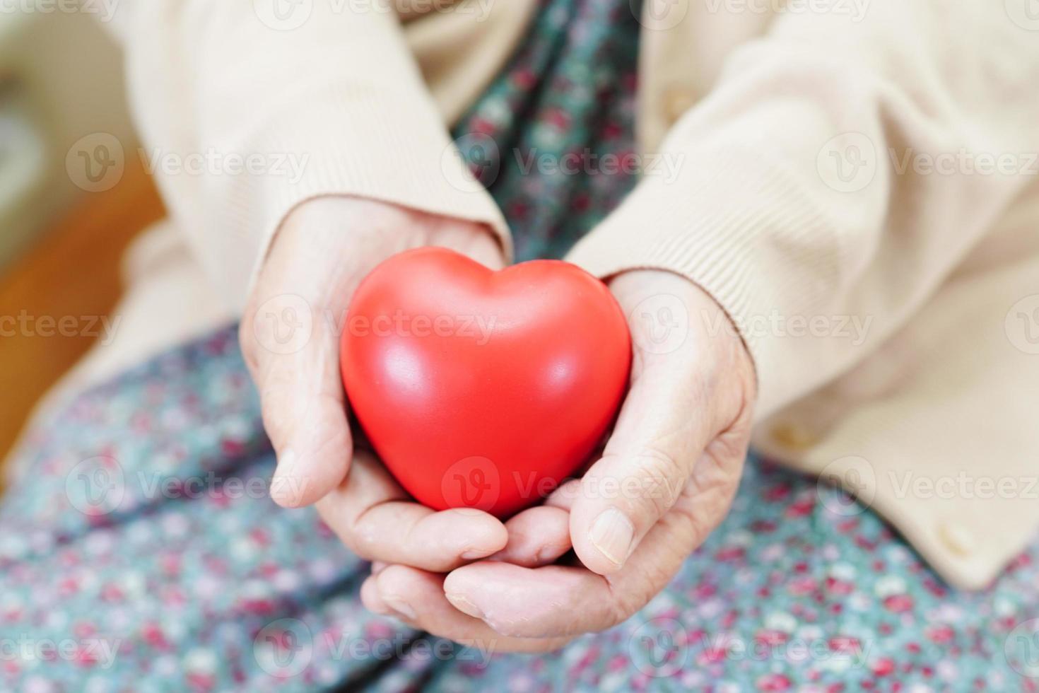 anciana asiática anciana paciente con corazón rojo en el hospital. foto