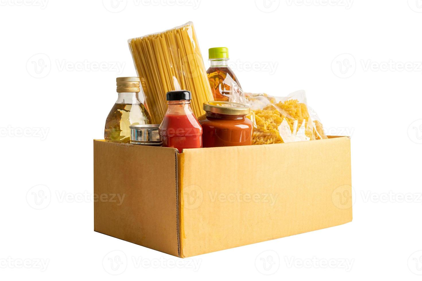 Foodstuff for donation, storage and delivery. Various food, pasta, cooking oil and canned food in cardboard box. photo