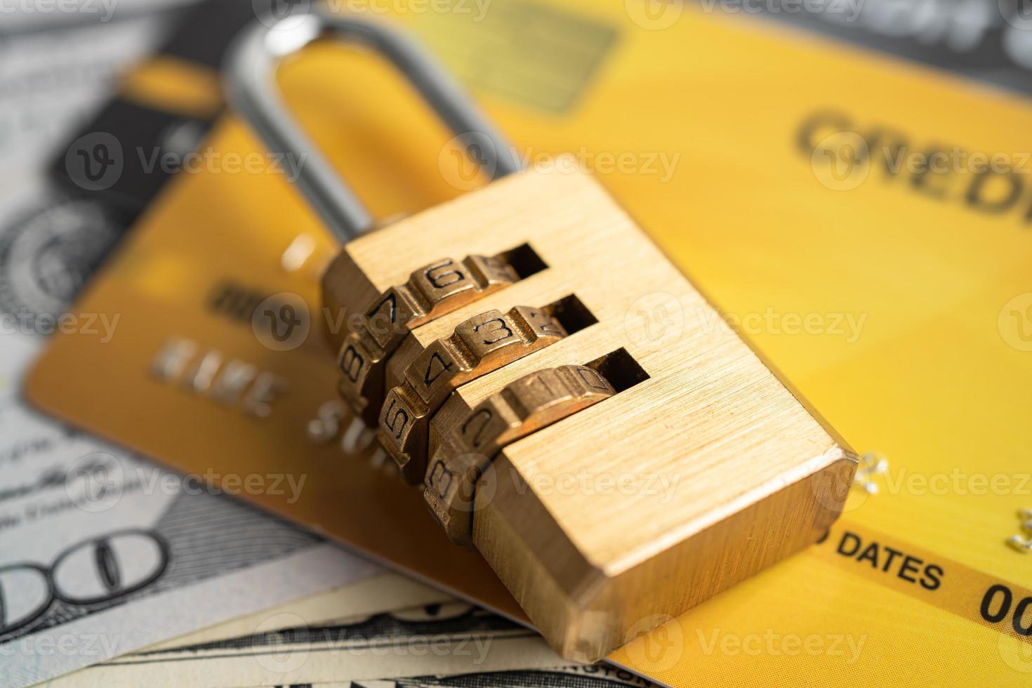 Credit card with password key lock and US dollar banknotes. photo