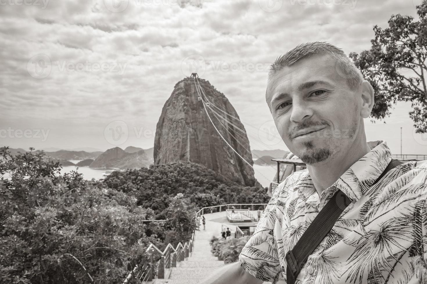 Tourist traveler poses at Sugarloaf mountain Rio de Janeiro Brazil. photo