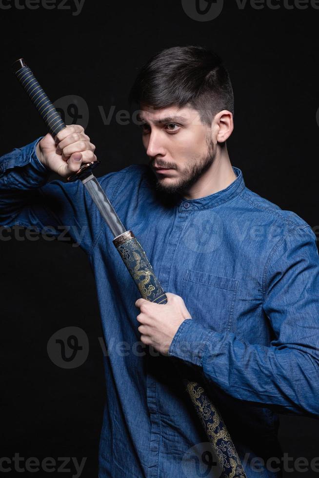 Serious young man posing in studio photo
