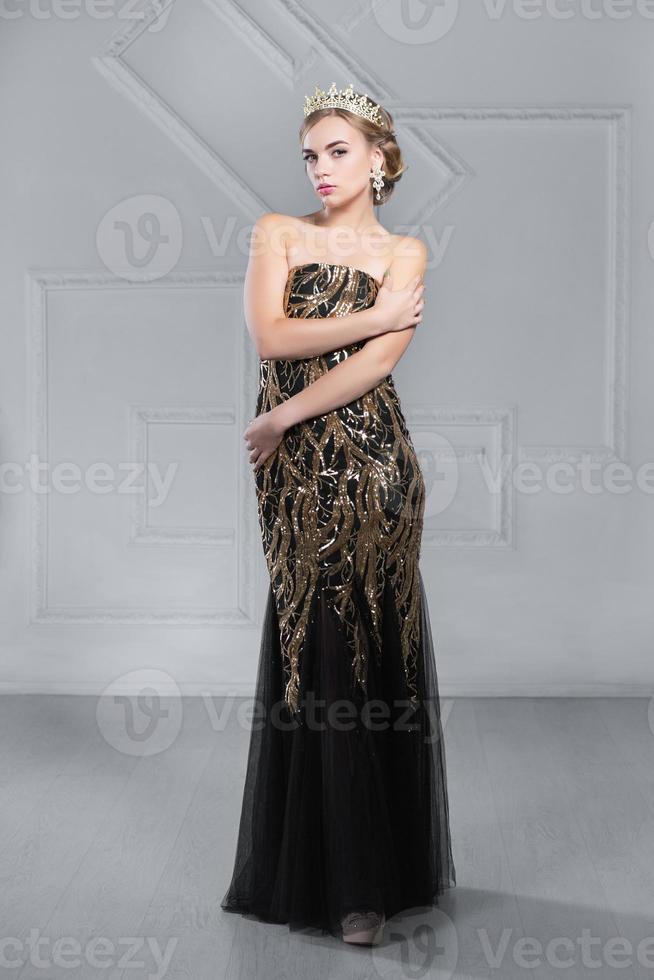 Young blonde woman posing in studio photo