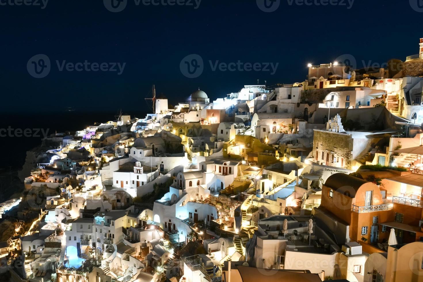 Classic Oia, Santorini skyline at night with buildings in Greece. photo