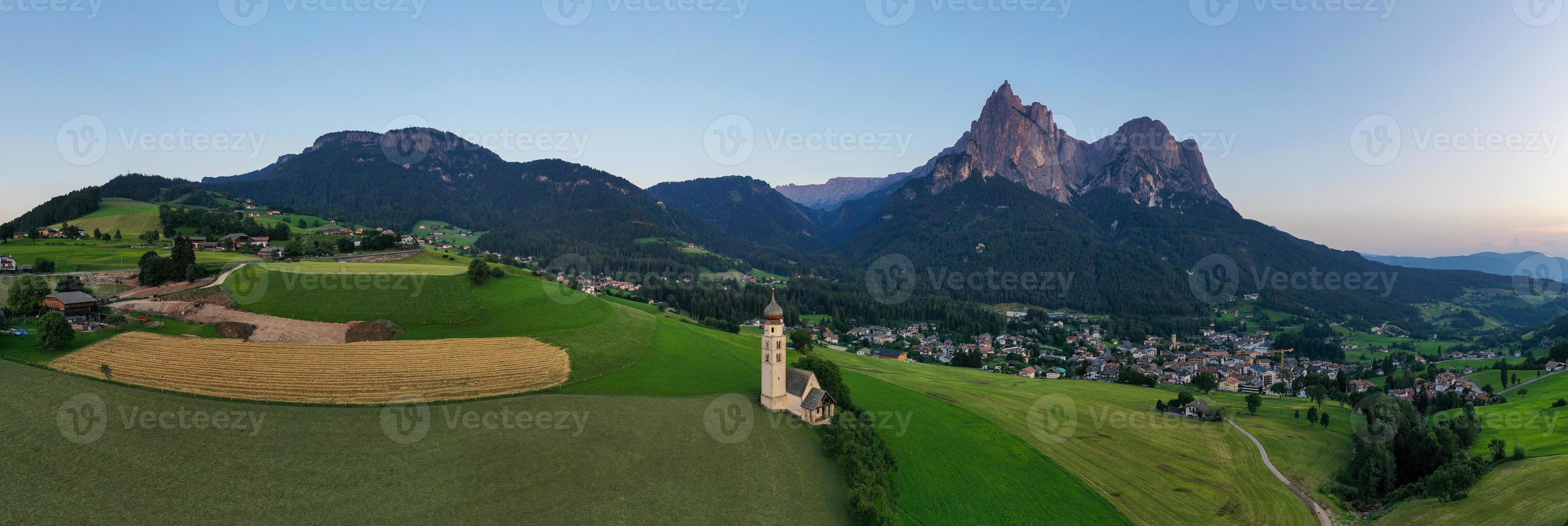 St. Valentin  Kastelruth  Village Church in the summer in the Dolomite Alps. Amazing landscape with small chapel on sunny meadow and Petz peak at Kastelruth commune. Dolomites, South Tyrol, Italy photo