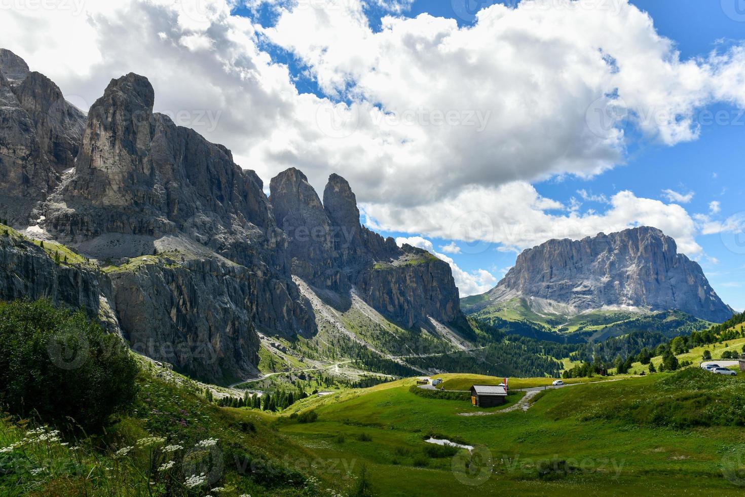 Colors of the Dolomites in the Funes view of the valley in Southern Tyrol, Italy. Green grass, mountains and blue sky. Summer. photo