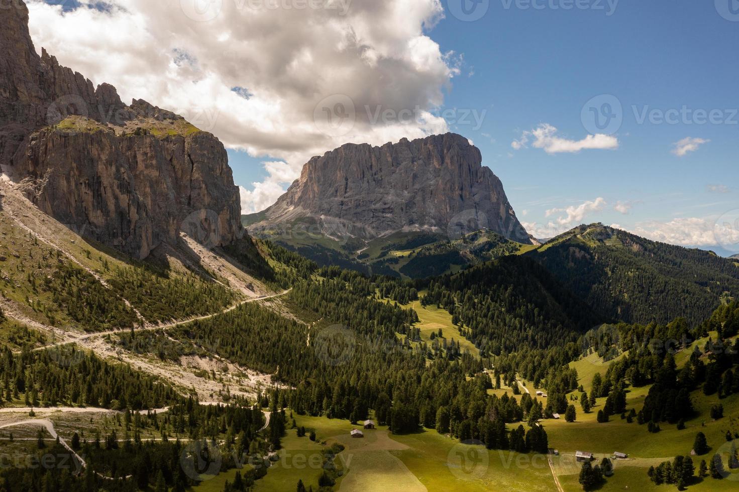 Colors of the Dolomites in the Funes view of the valley in Southern Tyrol, Italy. Green grass, mountains and blue sky. Summer. photo