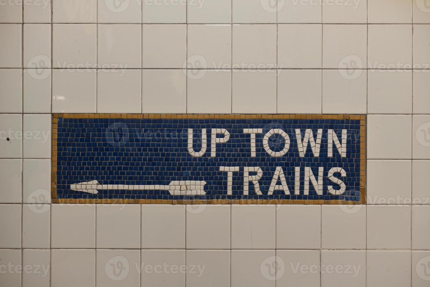 Tiled New York City subway train sign with arrow pointing direction. photo