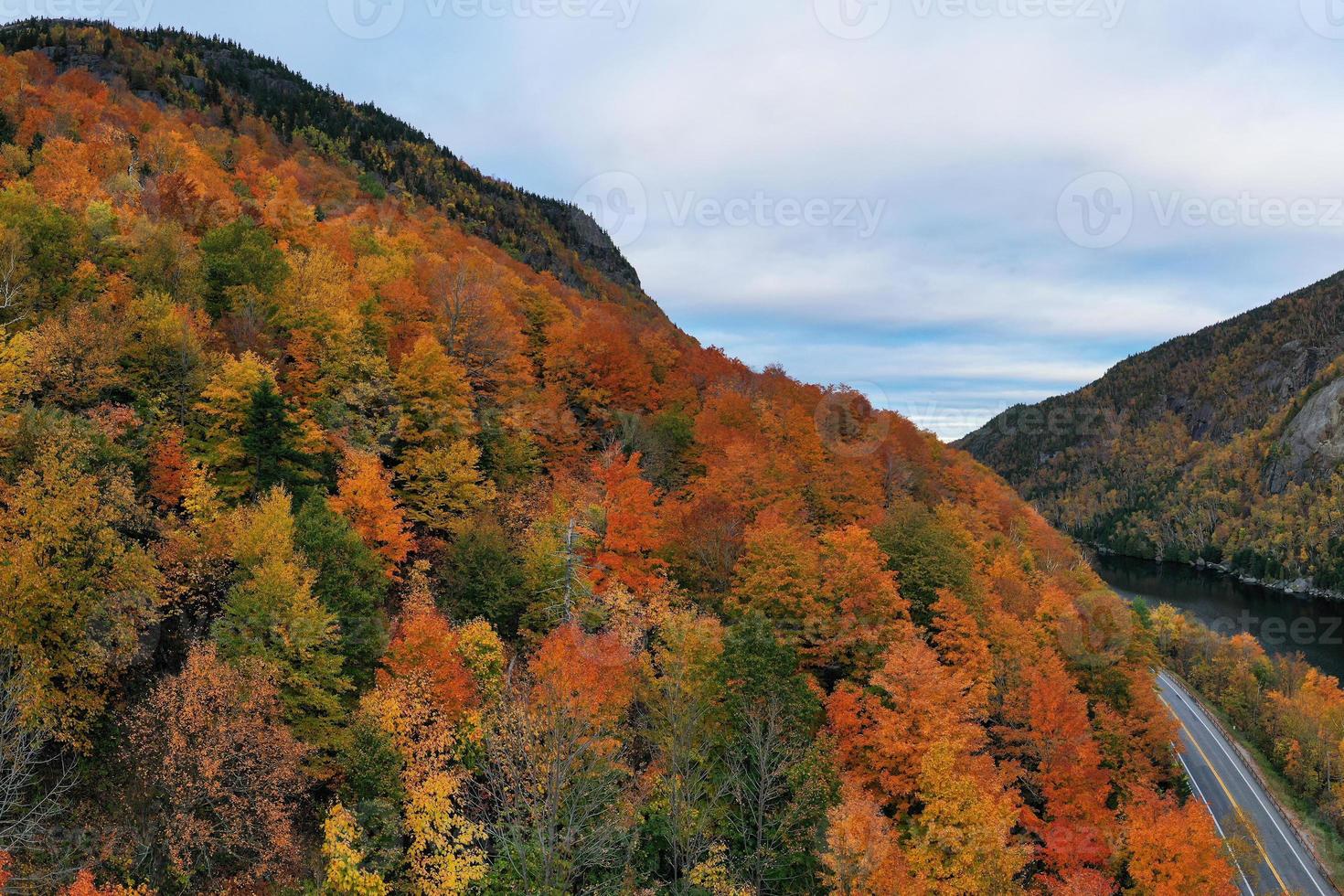 Peak fall foliage in Keene, New York by Cascade Lake. photo