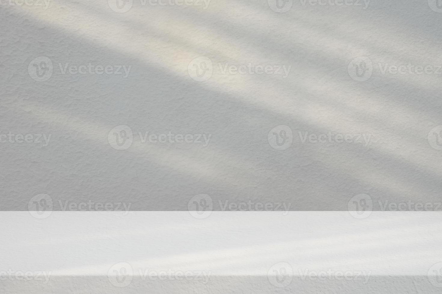 Stucco Table with White Concrete Wall Texture Background with Light Beam and Shadow, Suitable for Product Presentation Backdrop, Display, and Mock up. photo