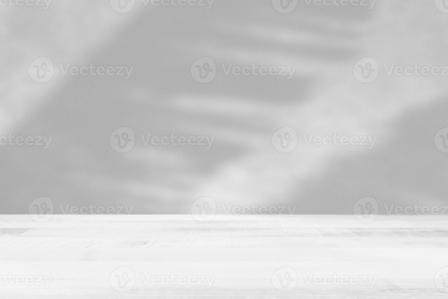 White Wooden Table with Banana Leaves on Concrete Wall Background, Suitable for Product Presentation Backdrop, Display, and Mock up. photo