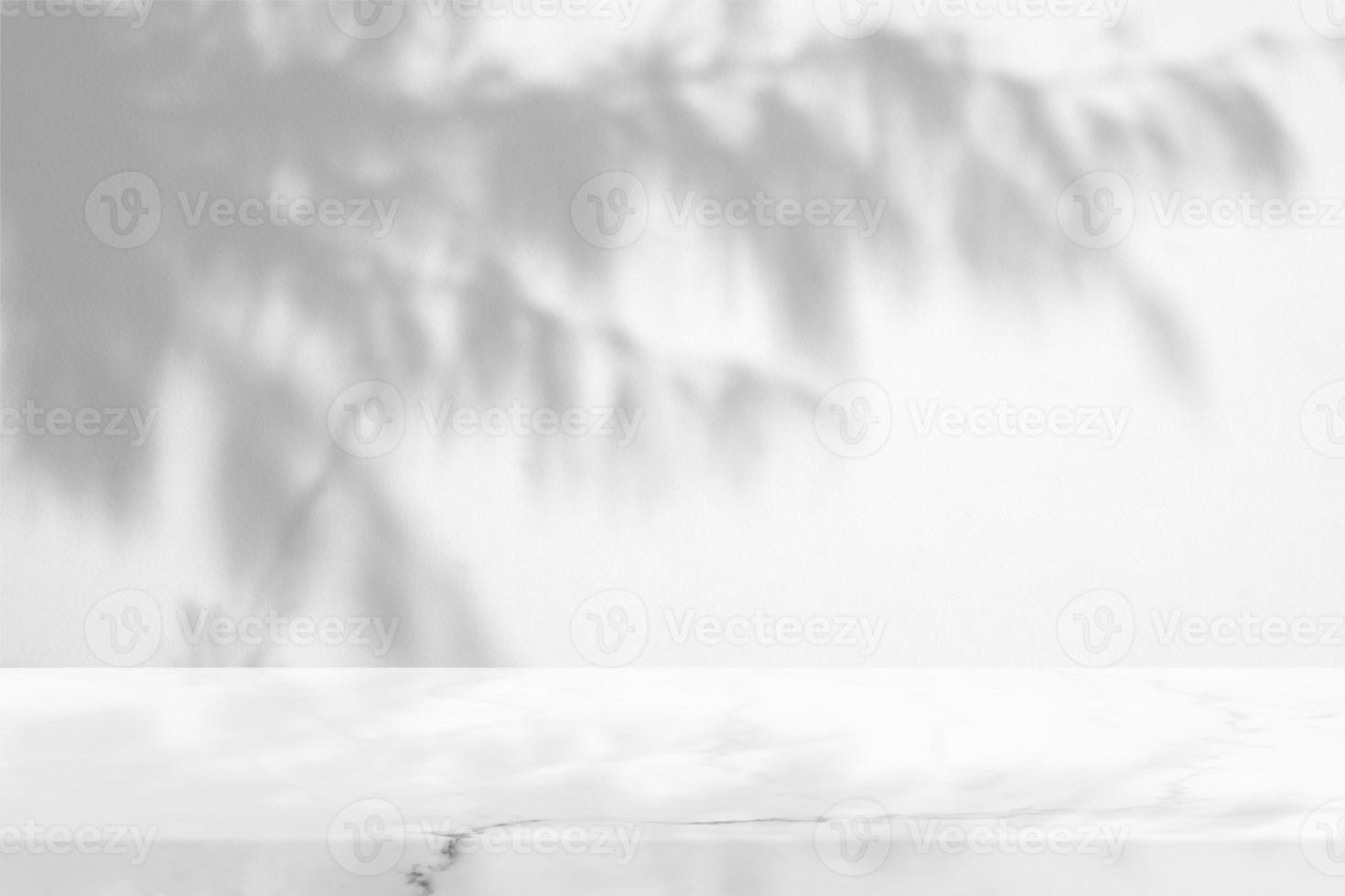 White Marble Table with Pine or Christmas Leaves Shadow on Concrete Wall Texture Background, Suitable for Product Presentation Backdrop, Display, and Mock up. photo