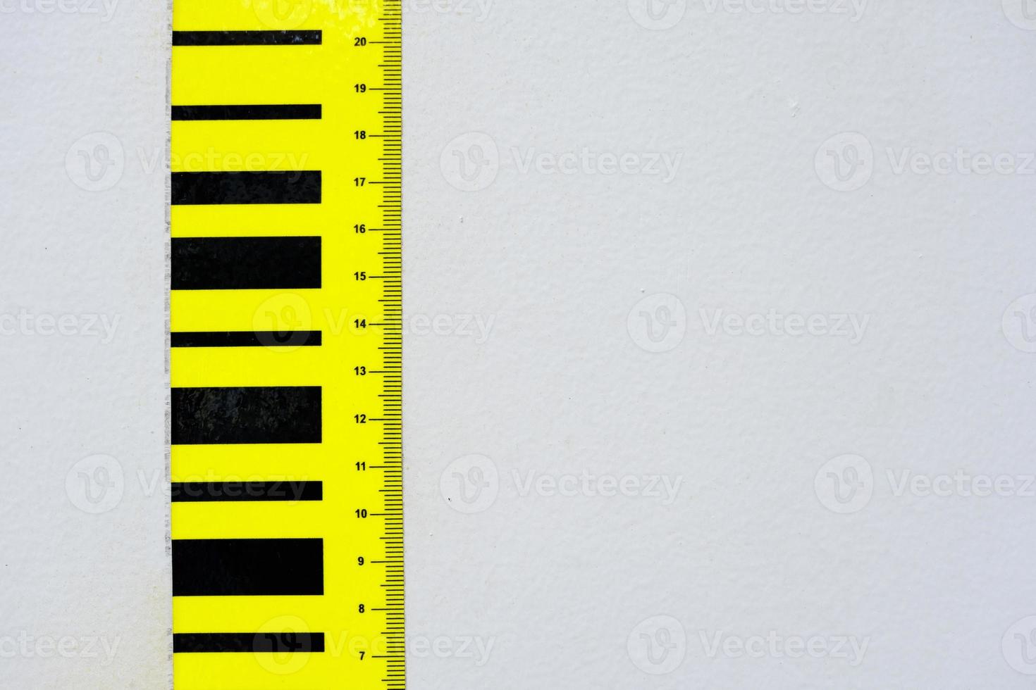 Centimeter Scale on White Concrete Wall Background. photo