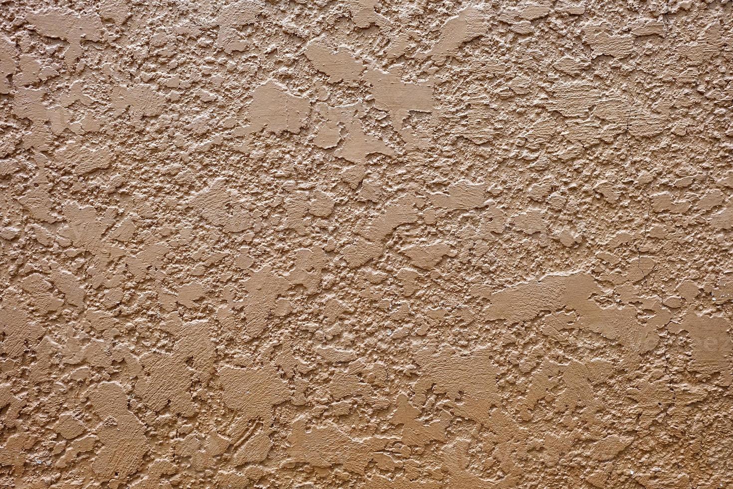 Brown Stucco Texture Wall Background with Light Leak from the Top. photo