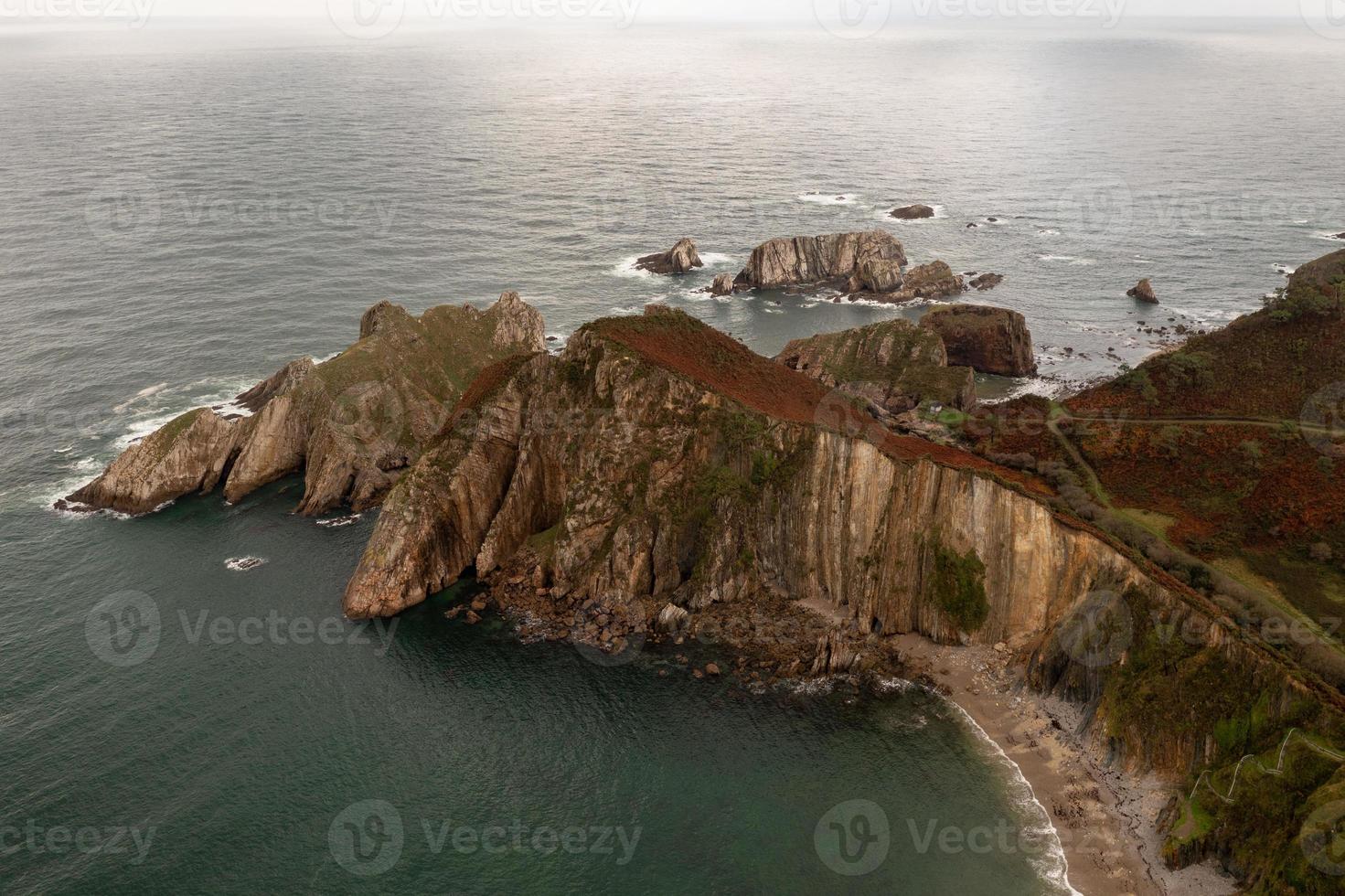 Silence beach, silver-sandy cove backed by a natural rock amphitheatre in Asturias, Spain. photo