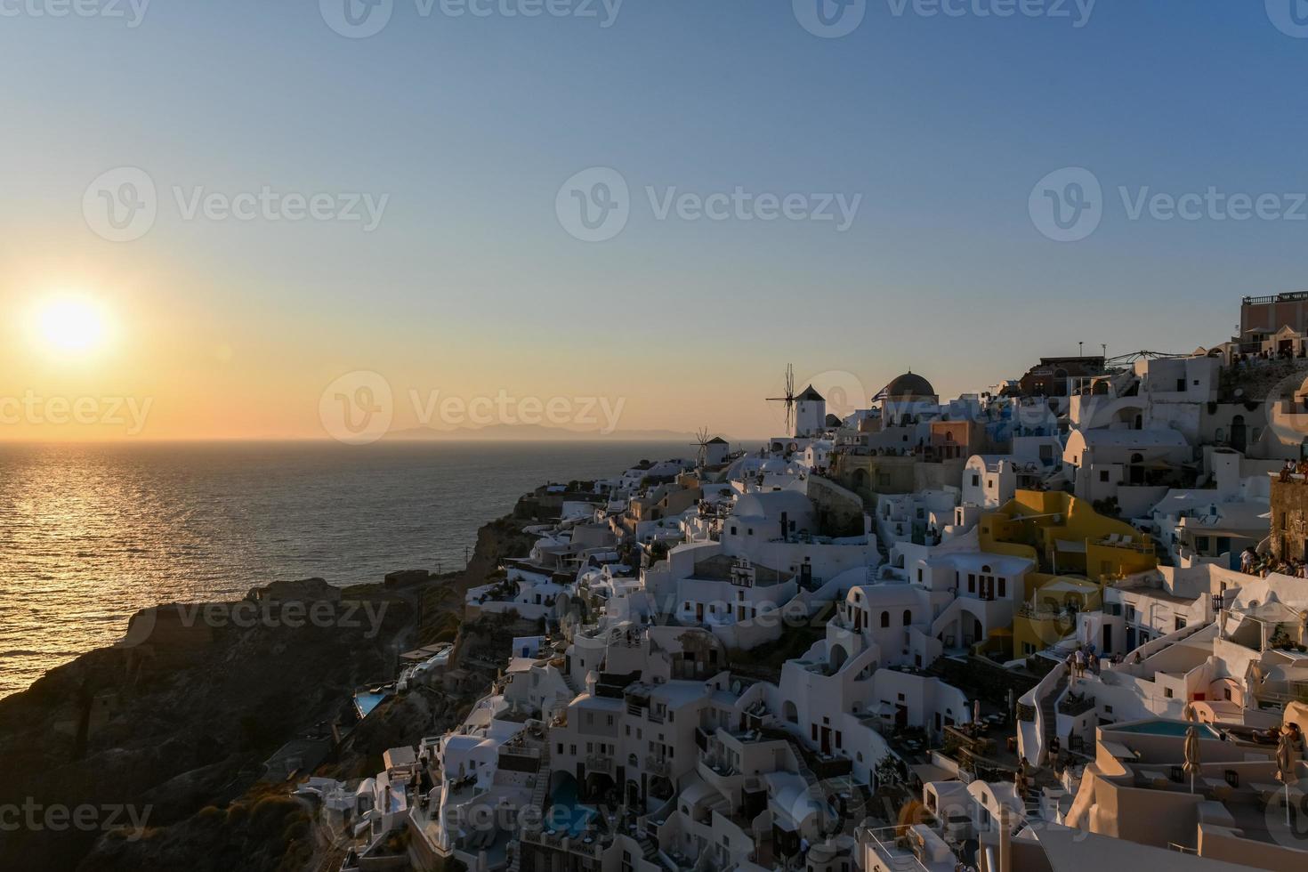 Classic Oia, Santorini skyline at sunset with buildings in Greece. photo