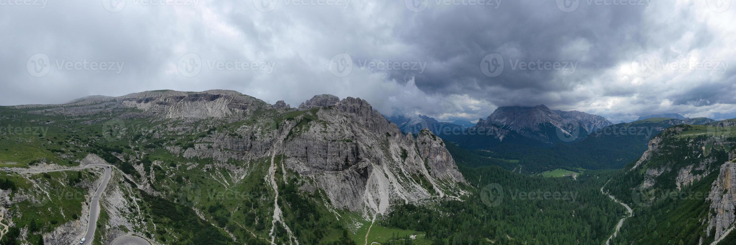 Mountain landscape surrounding Tre Cime park in Italy on a foggy, cloudy, summer, day. photo