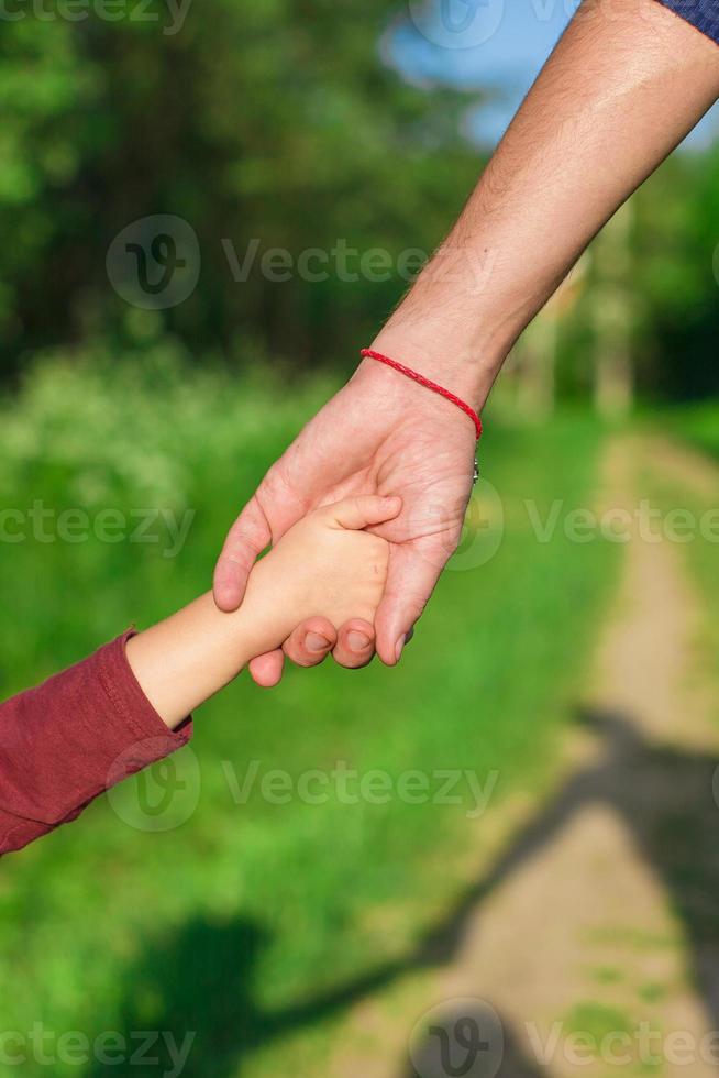 Father and daughter holding hands photo