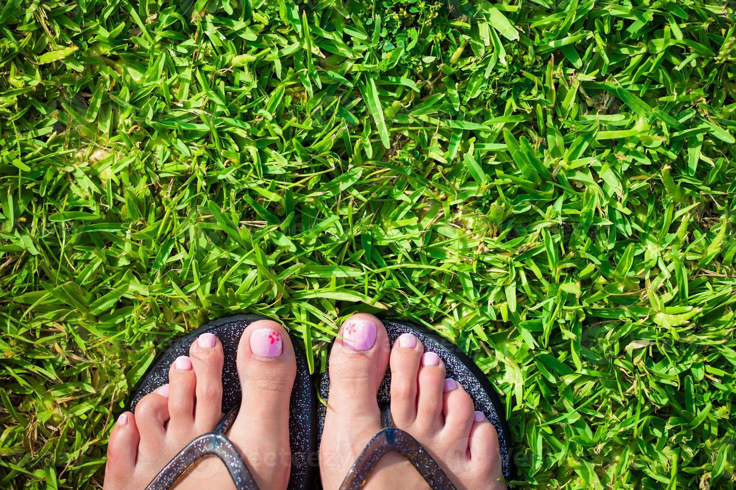 Feet on the grass close-up photo