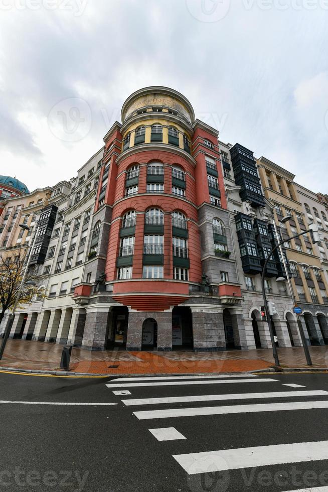 Beautiful architecture along Plaza Euskadi in Bilbao, Spain on a cloudy day. photo