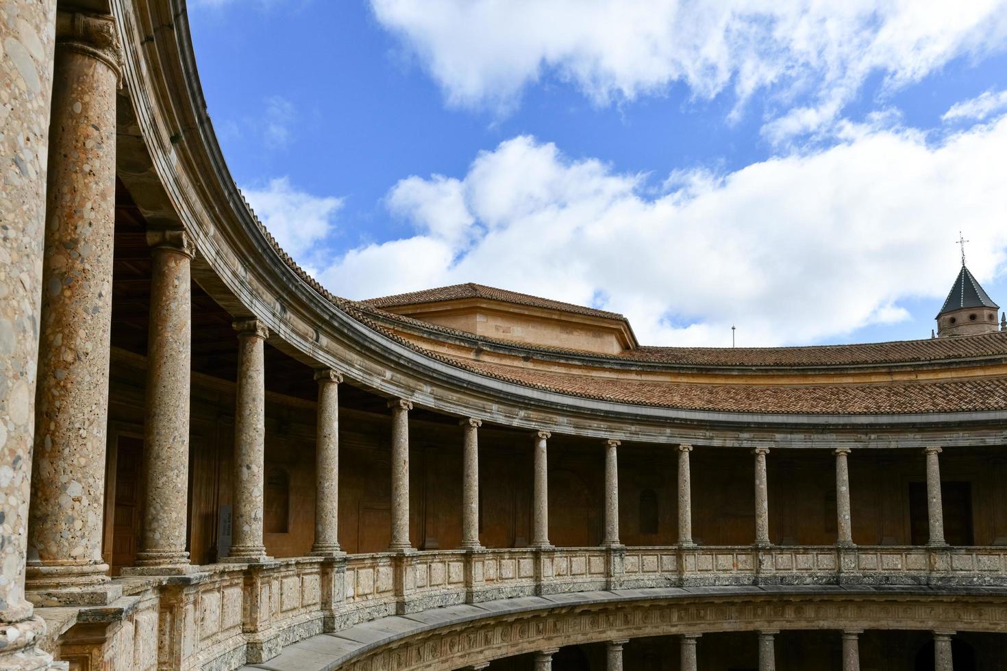 Granada, Spain - Nov 29, 2021, The unique circular patio of the Palace of Charles V  Palacio de Carlos V  with its two levels of columns of Doric and Ionic colonnades, Alhambra, Granada, Spain. photo