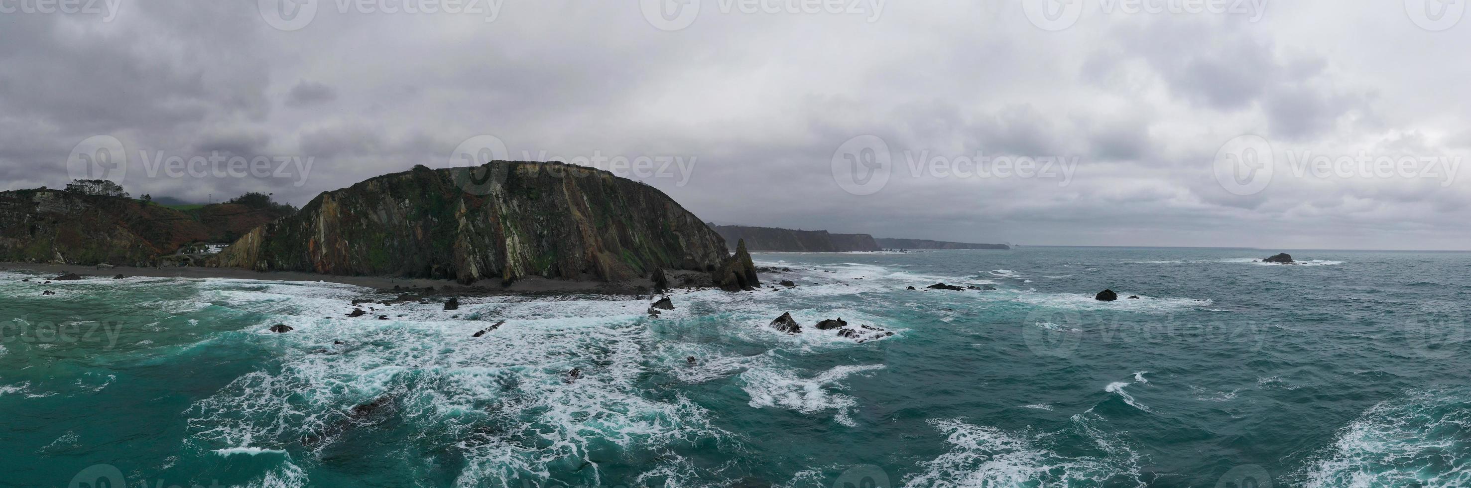 Aerial view of Campiecho beach is located in Asturias, Spain on a cloudy day. photo