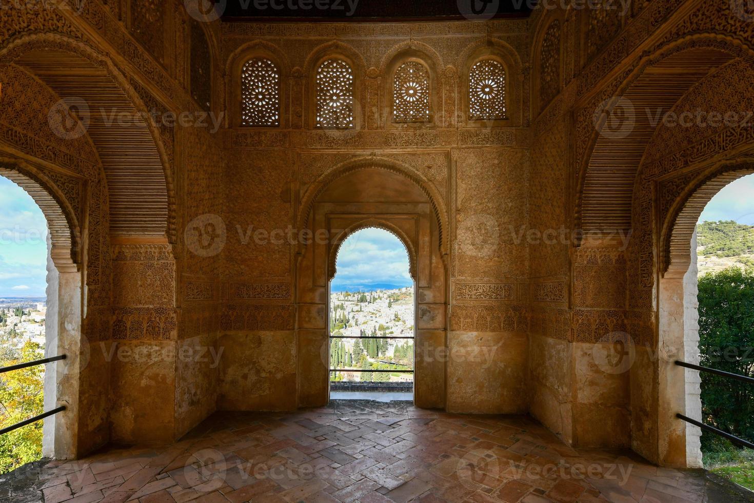 View of The Generalife courtyard, with its famous fountain and garden through an arch. Alhambra de Granada complex at Granada, Spain, Europe on a bright winter day. photo