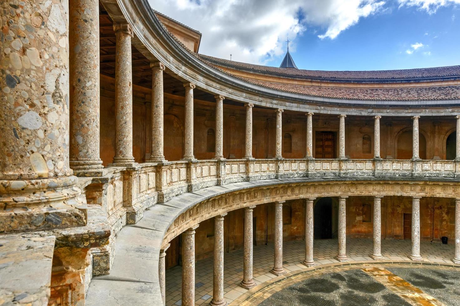 The unique circular patio of the Palace of Charles V  Palacio de Carlos V  with its two levels of columns of Doric and Ionic colonnades, Alhambra, Granada, Spain. photo