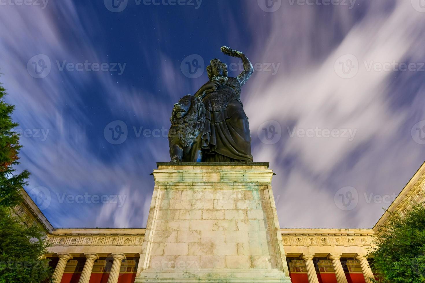 Munich, Germany - Jul 19, 2021, Bavaria Statue and Ruhmeshalle  Hall of Fame  in Munich, Germany, Theresienwiese at night. The statue was built in 1850. photo