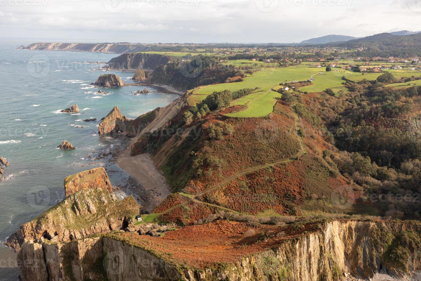 Silence beach, silver-sandy cove backed by a natural rock amphitheatre in Asturias, Spain. photo