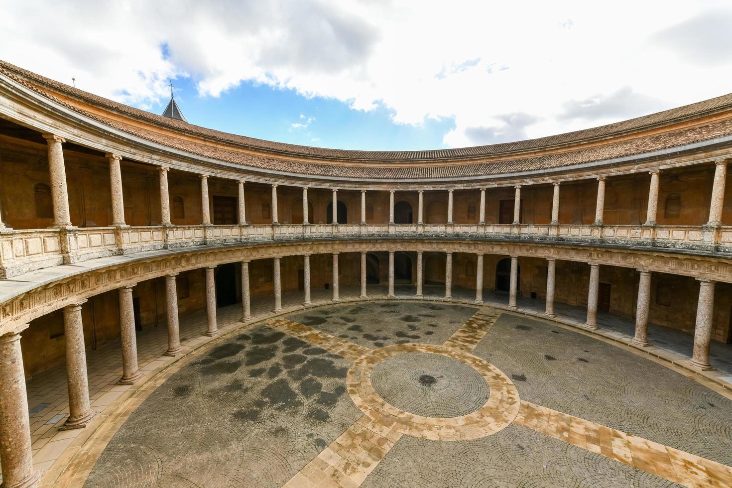 The unique circular patio of the Palace of Charles V  Palacio de Carlos V  with its two levels of columns of Doric and Ionic colonnades, Alhambra, Granada, Spain. photo