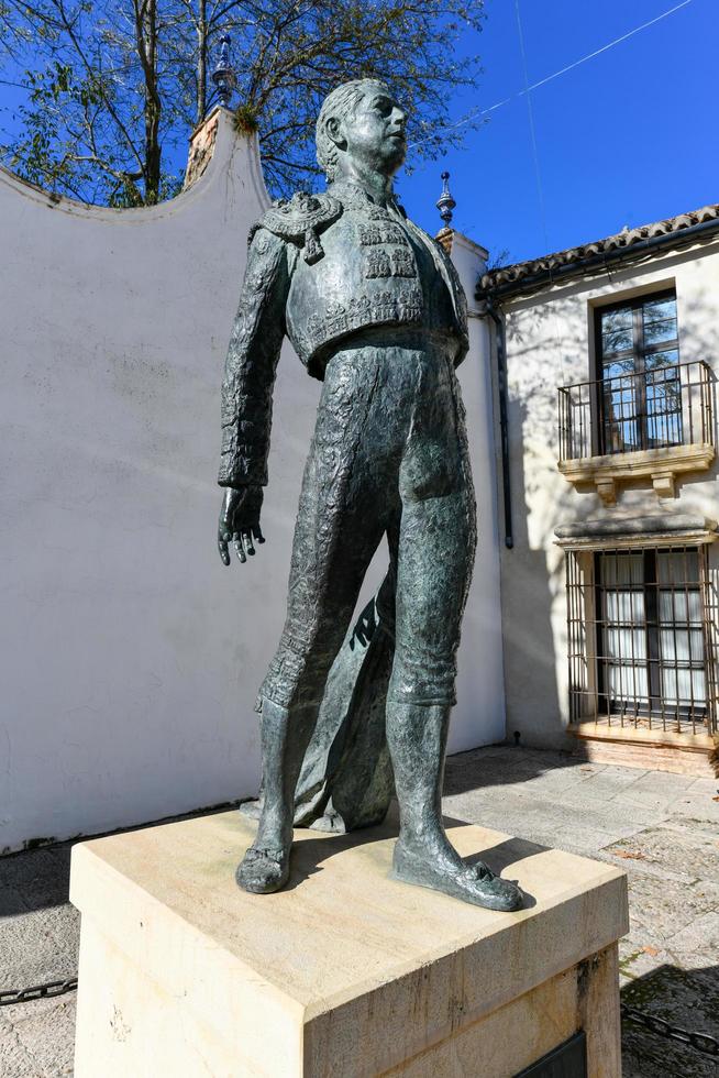 Ronda, Andalusia, Spain - Dec 1 2021, Outdoor statue of bullfighter Antonio Ordonez in front of the bullfighting arena photo