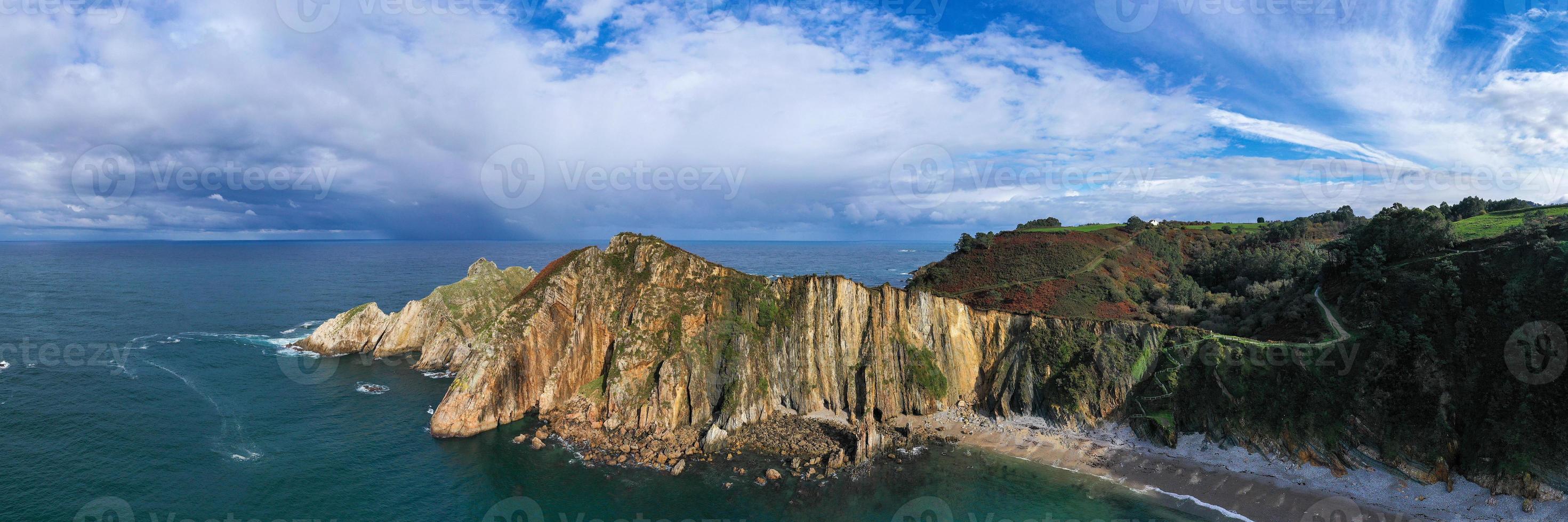 Silence beach, silver-sandy cove backed by a natural rock amphitheatre in Asturias, Spain. photo