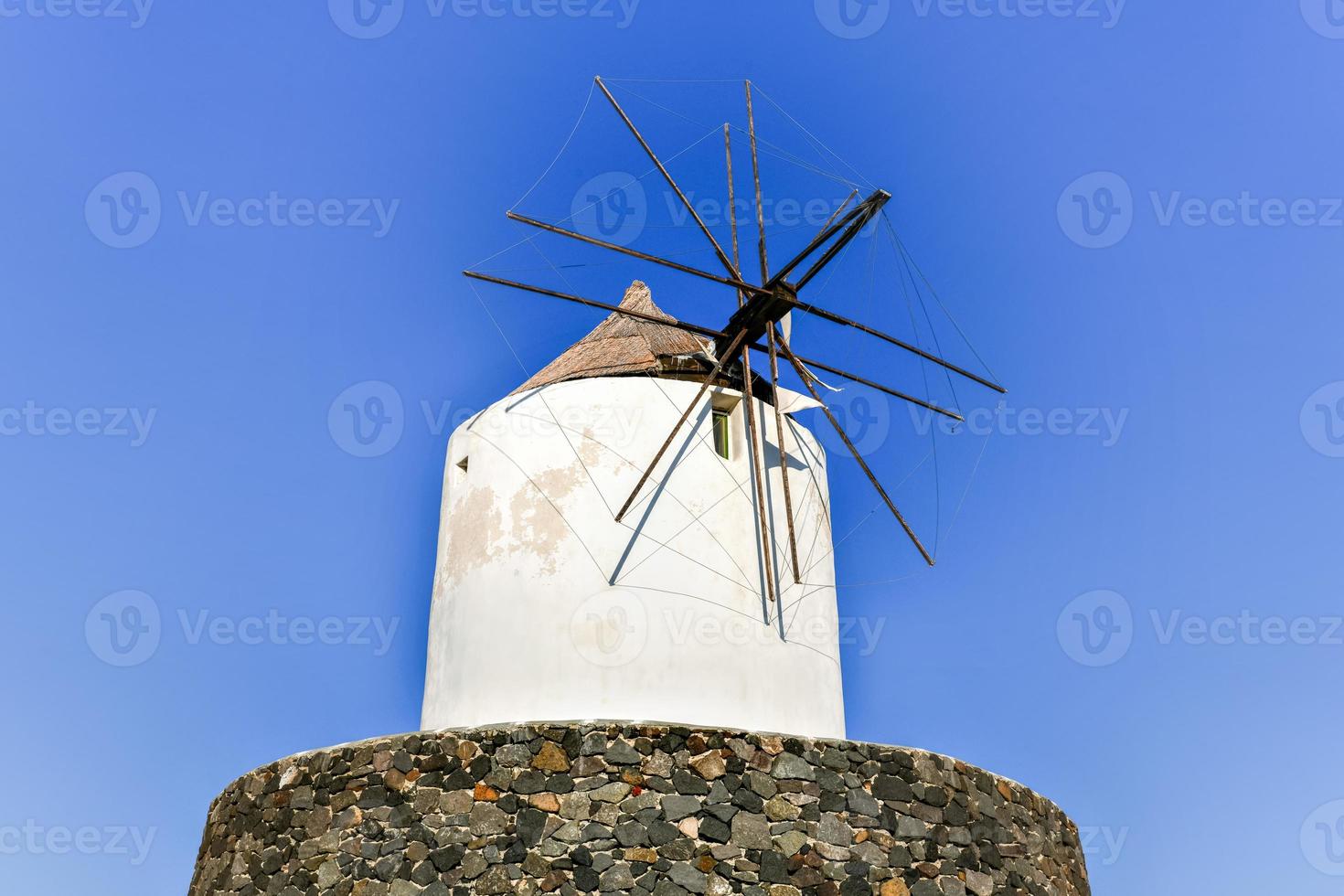 Ruins of old abandoned windmill in Emporio village on the south side of Santorni. Cyclades Islands, Greece. photo