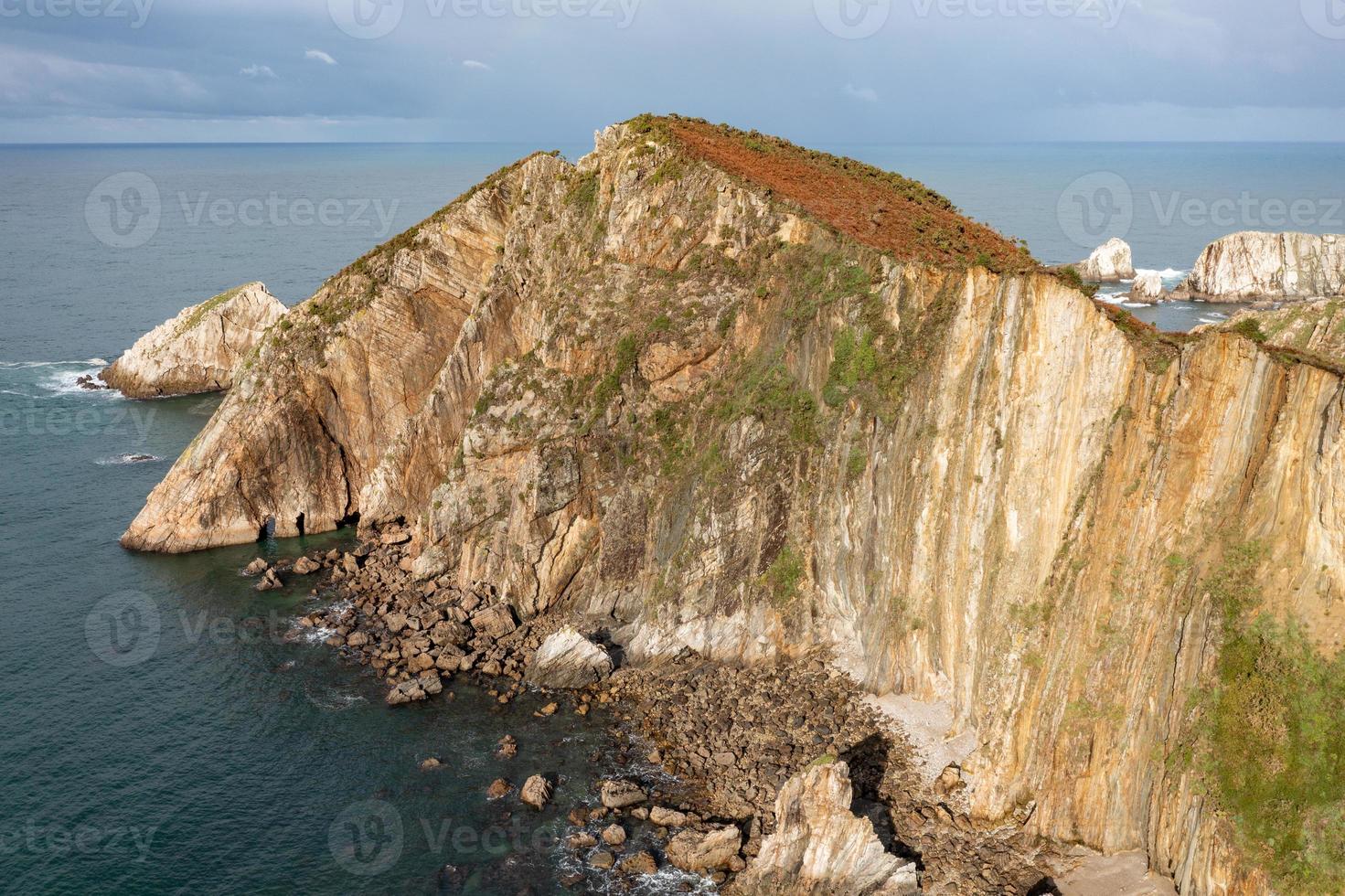 Silence beach, silver-sandy cove backed by a natural rock amphitheatre in Asturias, Spain. photo