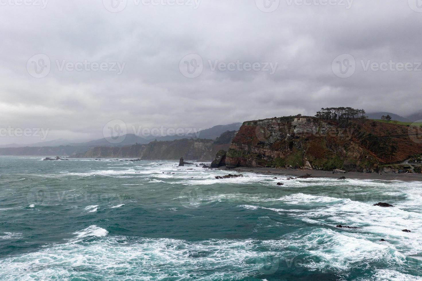 Aerial view of Campiecho beach is located in Asturias, Spain on a cloudy day. photo