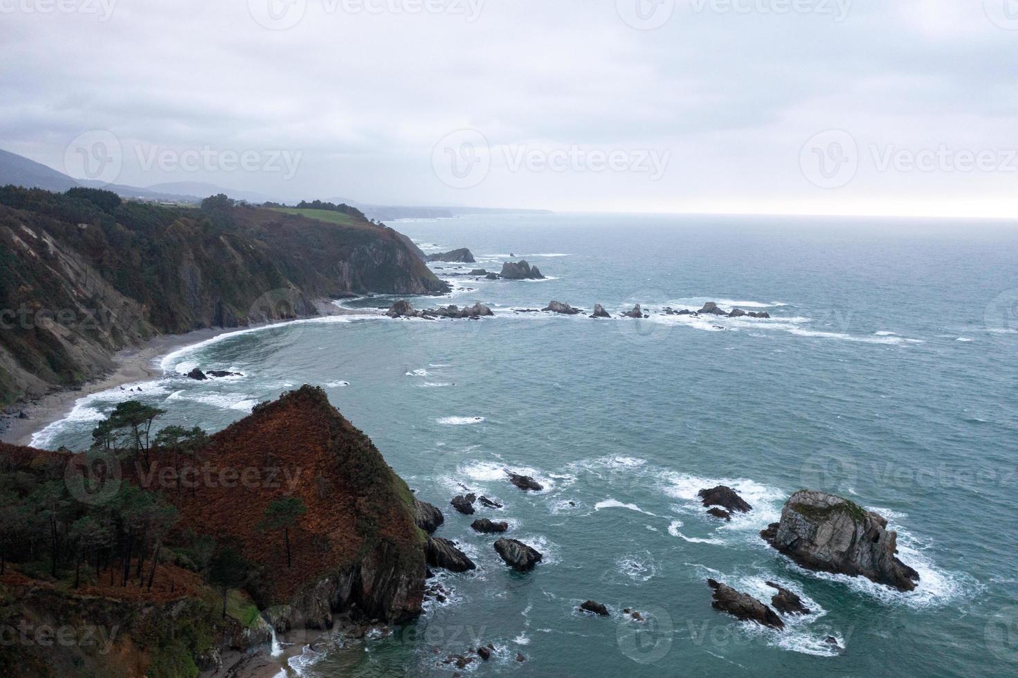 Silence beach, silver-sandy cove backed by a natural rock amphitheatre in Asturias, Spain. photo