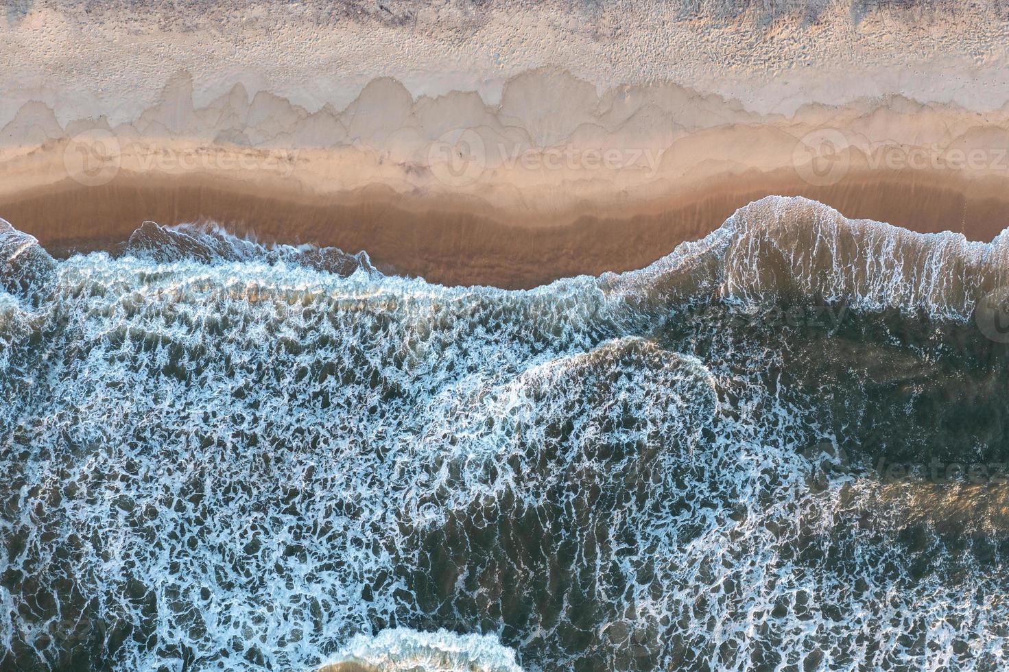 Waves flowing over the sand on the beach of Long Island, New York. photo