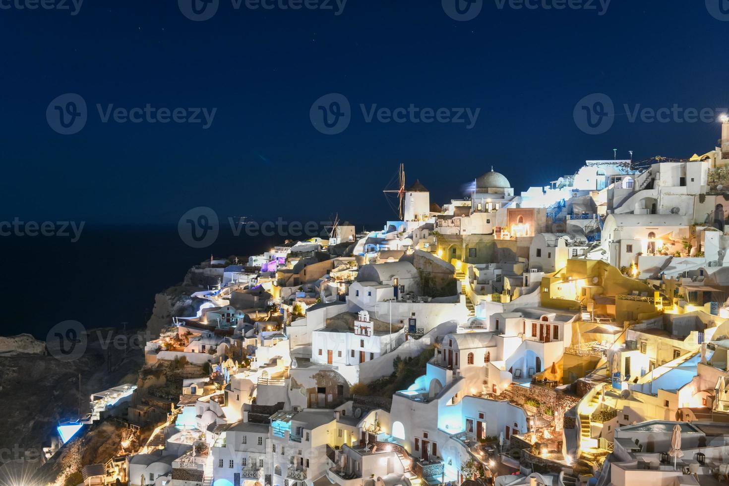 Classic Oia, Santorini skyline at night with buildings in Greece. photo